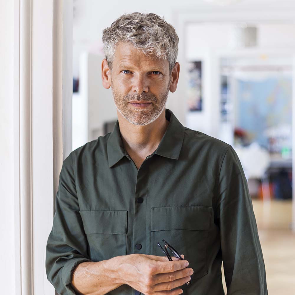 portrait of mature man with grey hair and stubble N2FETGY